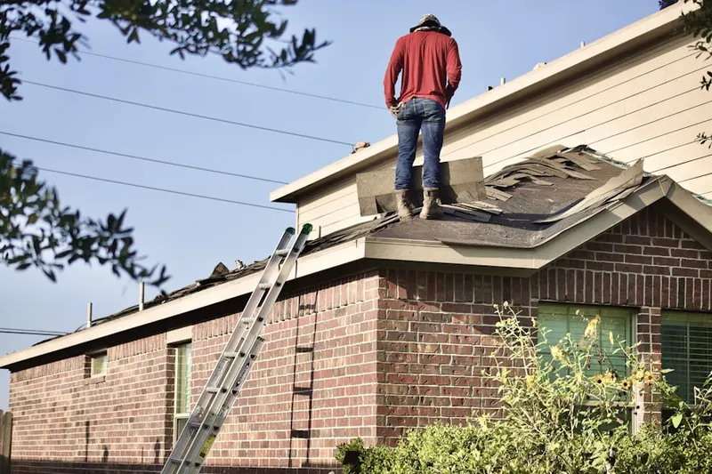 Professional roofer working on a residential roof in Oakland Hills